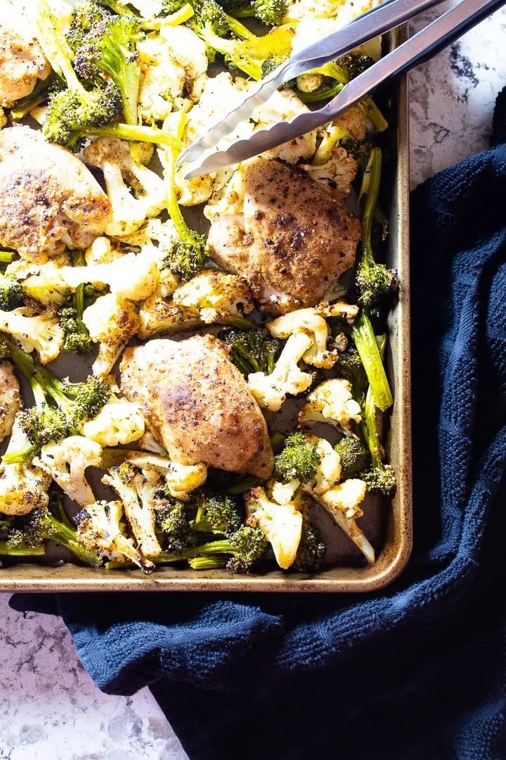 Sheet pan chicken thighs with broccoli and cauliflower.