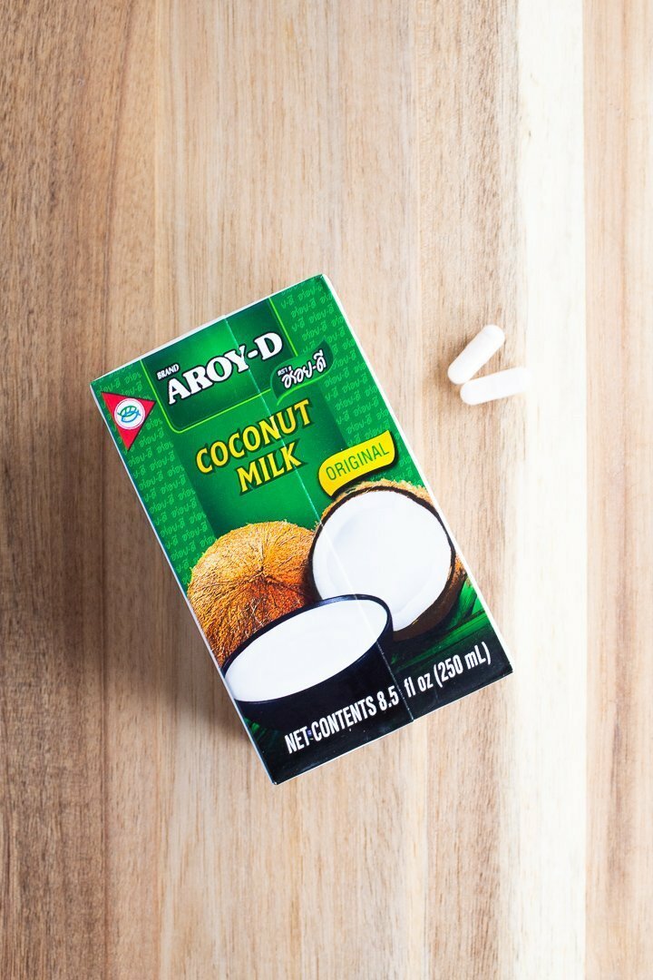 AIP coconut yogurt ingredients: coconut milk and probiotic capsules.