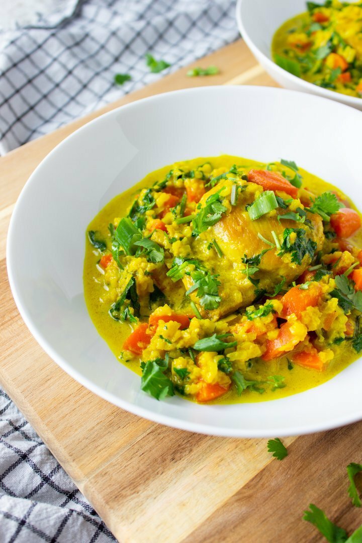 Close up of Turmeric Chicken and Cauli Rice in a white bowl.