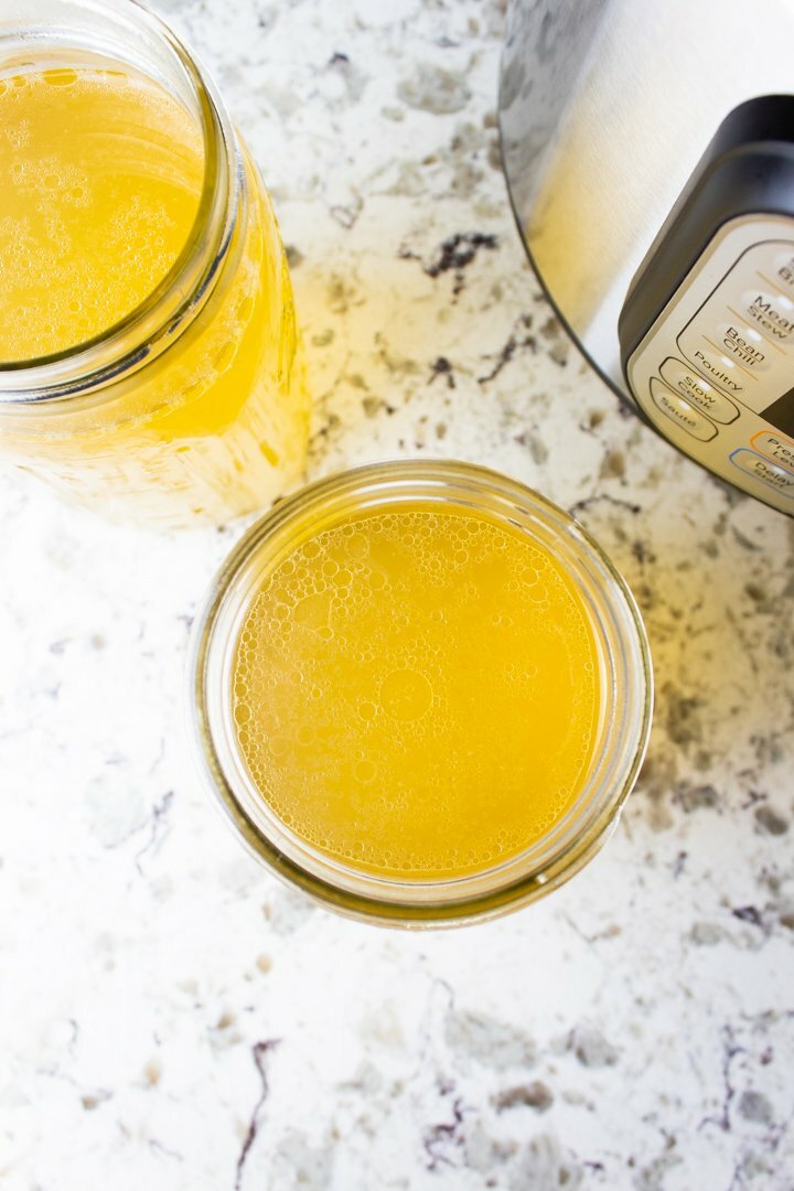 Top view of bone broth in glass mason jars.